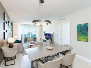 a dining room and living room with a table and chairs at Luxury Ocean Escape by Cielo Stays in Hollywood