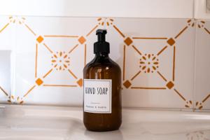 a bottle of land supreme liquid soap sitting on a counter at MONOLOCALE CASENUOVE con GIARDINO in Castiglioncello