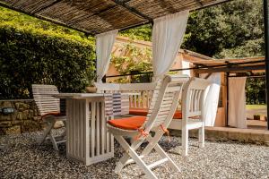 a group of chairs and a table on a patio at MONOLOCALE CASENUOVE con GIARDINO in Castiglioncello