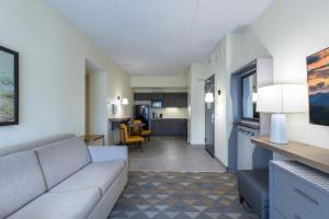 a living room with a couch and a kitchen at The Scenic Hotel at Biltmore Village in Asheville