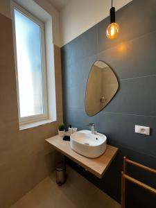 a bathroom with a sink and a mirror at Valguarnera Studio Apartments in Palermo