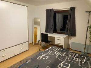 a bedroom with a bed and a desk and a mirror at Märchenhafte FeWo White auf dem Berg im Sauerland in Werdohl