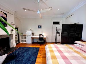 a bedroom with a bed and a desk in it at Paul’s Boutique in Sydney