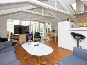 a living room with a couch and a table at 6 person holiday home in R nde in Rønde