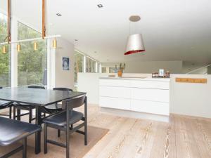 eine Küche und ein Esszimmer mit einem Tisch und Stühlen in der Unterkunft 8 person holiday home in Ebeltoft in Ebeltoft