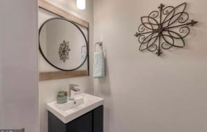 a bathroom with a sink and a mirror at Beautiful Canton Home w/rooftop deck +Private parking in Baltimore