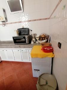 a small kitchen with a counter and a microwave at Spacieux appartement familial in Agadir