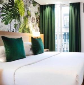 a bedroom with a large white bed with green curtains at Seven Luxury Suites in Belgrade