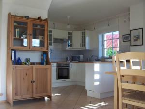 a kitchen with wooden cabinets and a counter top at Strandrose in Brasilien +5 photos