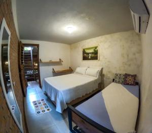 a small bedroom with a bed and a table at Pousada Ksa Zen Jeri in Jericoacoara