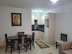 a kitchen and dining room with a table and chairs at Brayan guest house in Pogradec