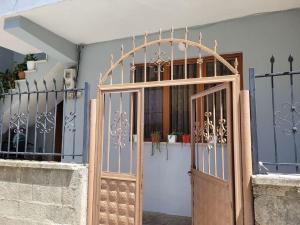 a wooden door with a gate in front of a building at Brayan guest house in Pogradec
