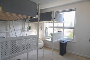 a room with a bunk bed and a window at Sunsets At Glenelg in Glenelg +10 photos