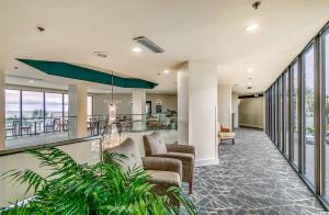 a lobby of a hotel with chairs and windows at Oceanview Studio Escape With Beach Steps Away! 1828 in Myrtle Beach