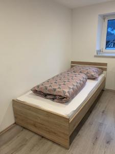 a bedroom with a bed with a wooden bed frame at Haus CM in Nüziders