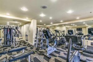 a gym with several treadmills and elliptical machines at Oceanview Studio Escape With Beach Steps Away! 1828 in Myrtle Beach