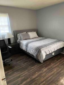 a bedroom with a bed and a desk and a chair at Cozy 4 Bedroom Near Airport in Montgomery