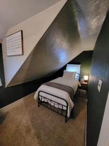 a bedroom with a bed in a attic at Cozy Little Getaway in Winner