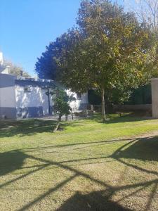 a yard with two trees and a house at La Aldea in Rodeo de la Cruz