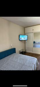 a bedroom with a bed and a flat screen tv at Jupiter Sea View in Benalmádena