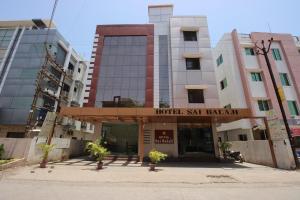 a hotel in the middle of some buildings at Hotel Sai Balaji in Shirdi