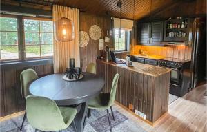 a kitchen with a table and chairs in a room at Pet Friendly Home In stby With Wifi in Østby
