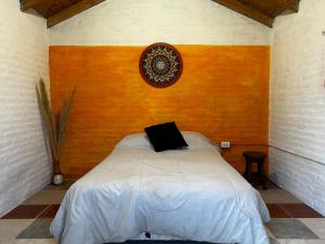 a bedroom with a bed with a laptop on it at RAMA GUEST HOUSE in Ciudad Lujan de Cuyo