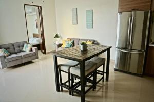 a kitchen with a table and a refrigerator and a couch at Casa Carmen Culebra- Suez in Culebra
