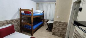 a small room with a bunk bed and a room with a bed at Melhor localização em Ilha Grande - 5min do cais in Abraão