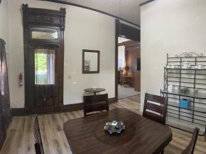 a living room with a wooden table and chairs at Dover Historic Building 1Bed w/Hot Tub 1st floor in Dover