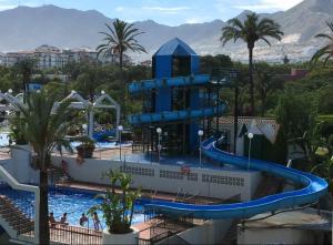 a water slide in a pool at a resort at Benal Beach in Benalmádena