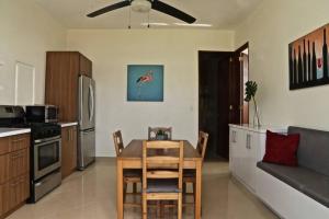 a kitchen with a table and a dining room at Casa Carmen Culebra- Atenas in Culebra