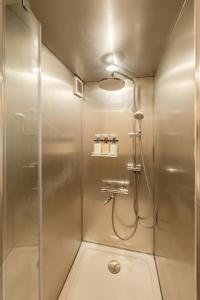a bathroom with a shower with a glass door at 本栖ベース～ヴィンテージトレーラーとバレルサウナ’1日1組限定’の貸切別荘～ in Fujikawaguchiko