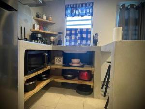 a kitchen with a counter with a microwave and a kitchen at Rota- Casa Carmen Culebra in Culebra