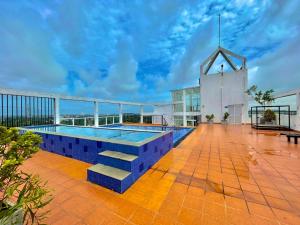 a pool on the roof of a building with a church at Aeonsky apartment Negombo beach and airport in Negombo