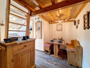 a kitchen with a table and a dining room at Appartement moderne mansardé Au pied des pistes Centre village - FR-1-344-860 in Saint-Martin-de-Belleville