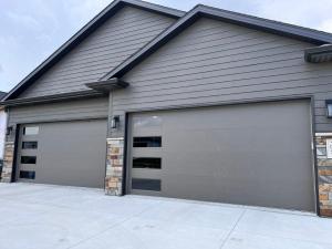 a pair of garage doors on a house at Petit Domicile QUEEN & TWIN Beds Main Floor in Lincoln