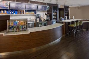 a bar in a restaurant with a counter and stools at Courtyard Houston Westchase in Houston