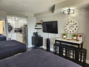 a bedroom with a large clock on the wall at Modern Beach Condo-Daytona Beach in Daytona Beach