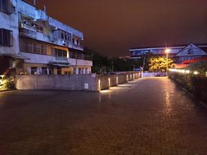 an empty street at night with a building at 王牌旅館 Ace Hotel in Hualien City