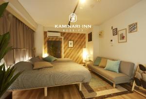 a bedroom with a bed and a couch at Kami Inn in Tokyo