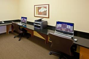 an office with two desks with two laptops on them at Candlewood Suites Lafayette by IHG in Lafayette