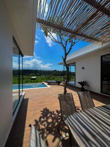 a patio with a table and chairs and a pool at Balisen Luxury Villas in Jasri