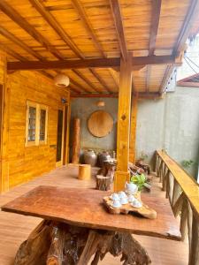 a wooden porch with a table and a wooden ceiling at Sun Hill's House in Cham Ta Lao