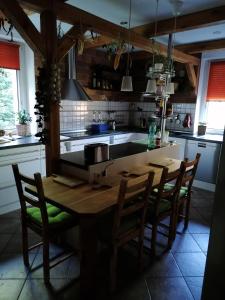 a kitchen with a wooden table and some chairs at Monteurunterkunft Maria in Freital