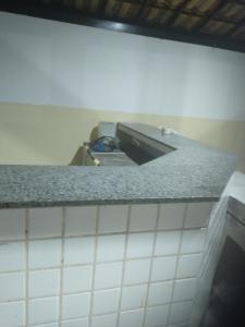 a kitchen with a counter top in a room at Aeroporto in Salvador