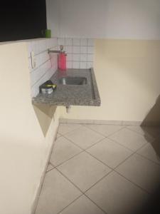 a kitchen with a sink and a tiled floor at Aeroporto in Salvador