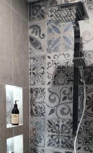 a shower in a bathroom with a tile wall at Room With A view in Napier