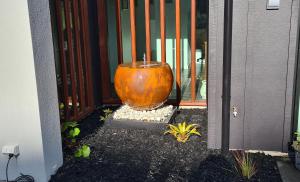 a large orange vase sitting in front of a door at Room With A view in Napier