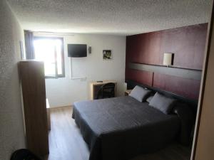 a bedroom with a bed with a red headboard at Hotel les Tourrades in Cannes